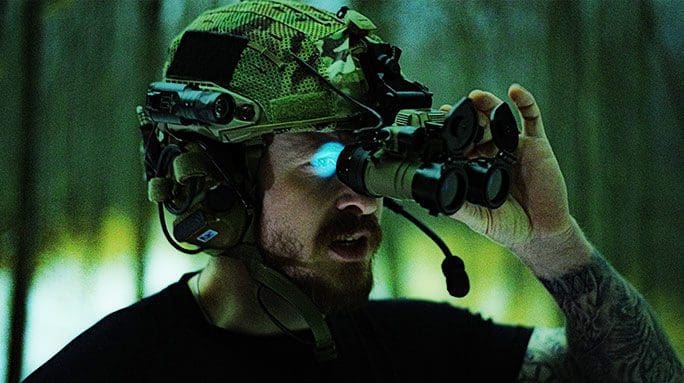 Soldier viewing night vision with binoculars